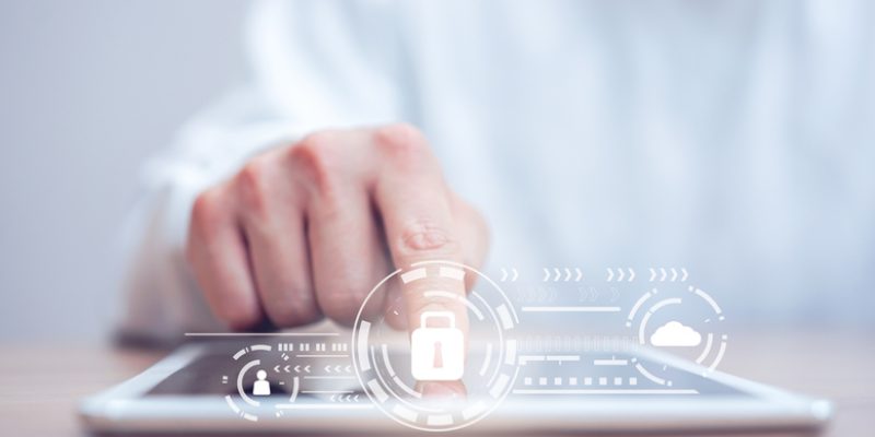 close up programmer man hand tap on digital tablet for register data system or access password with virtual interface protection of cyber security at operation room , futuristic technology concept