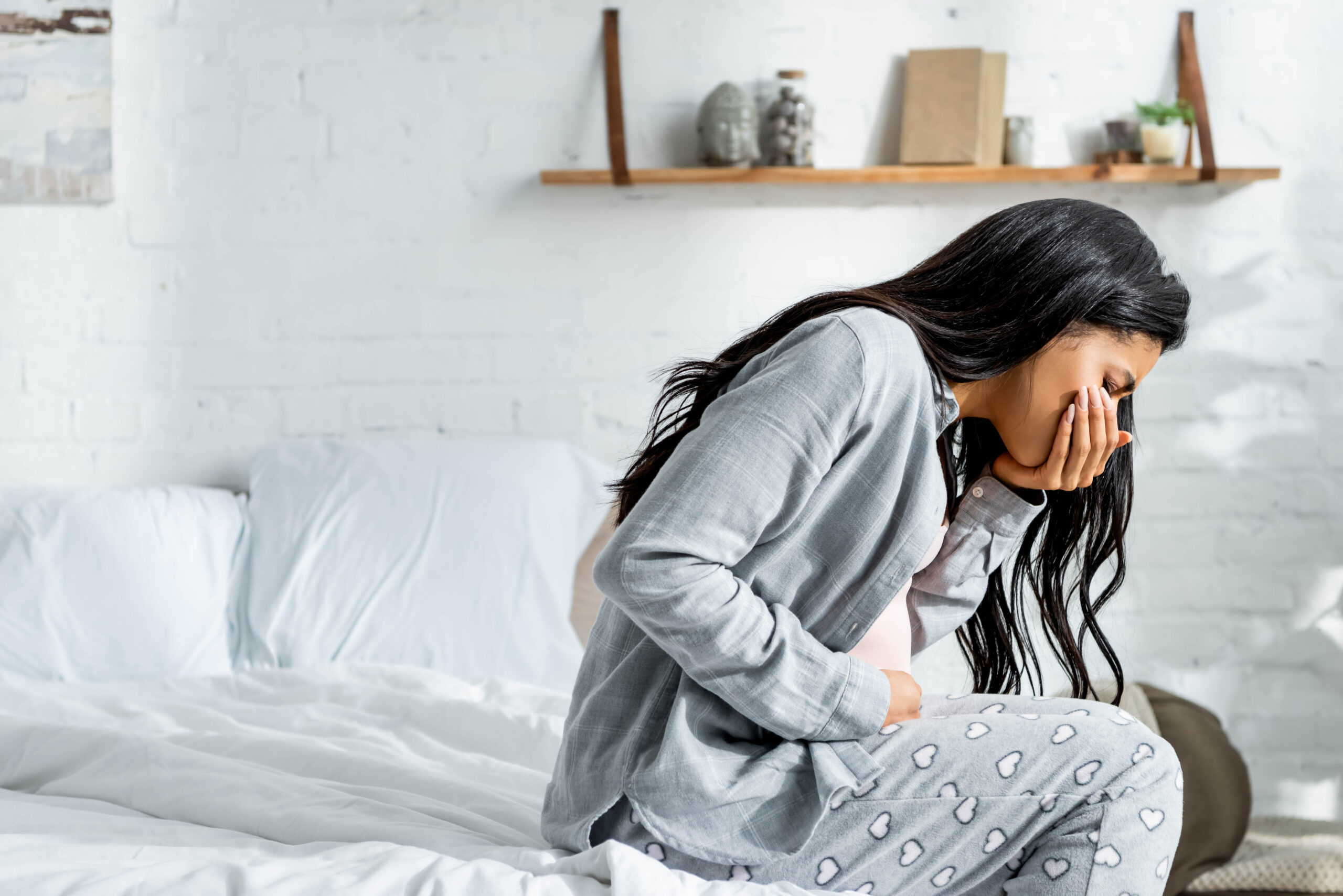 pregnant african american woman having toxicosis vomit in apartment