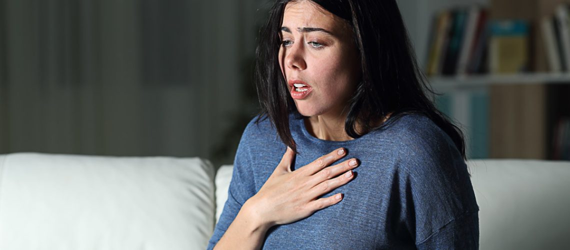 Woman suffering an anxiety attack alone in the night