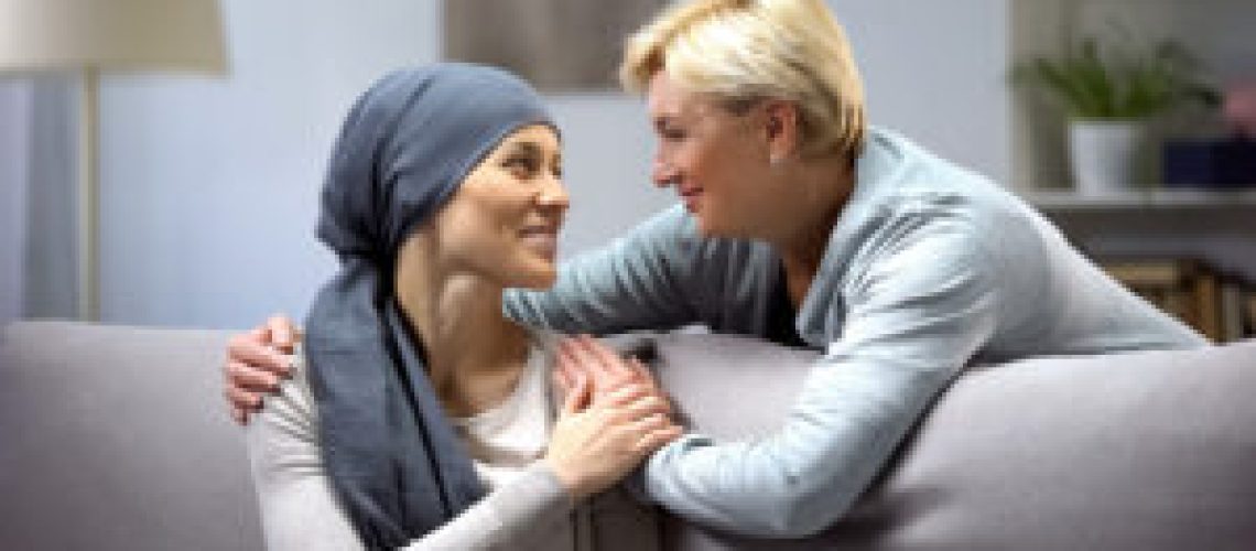 Smiling woman with cancer hugging mother, hope and togetherness, remission
