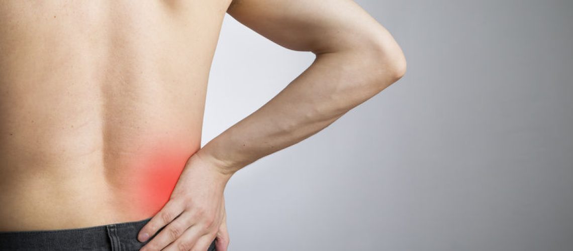 28277554 - pain in the lower back in men on gray