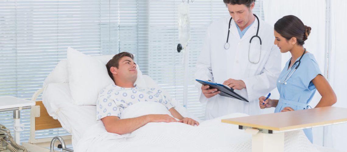 42226524 - doctors taking care of patient in hospital room