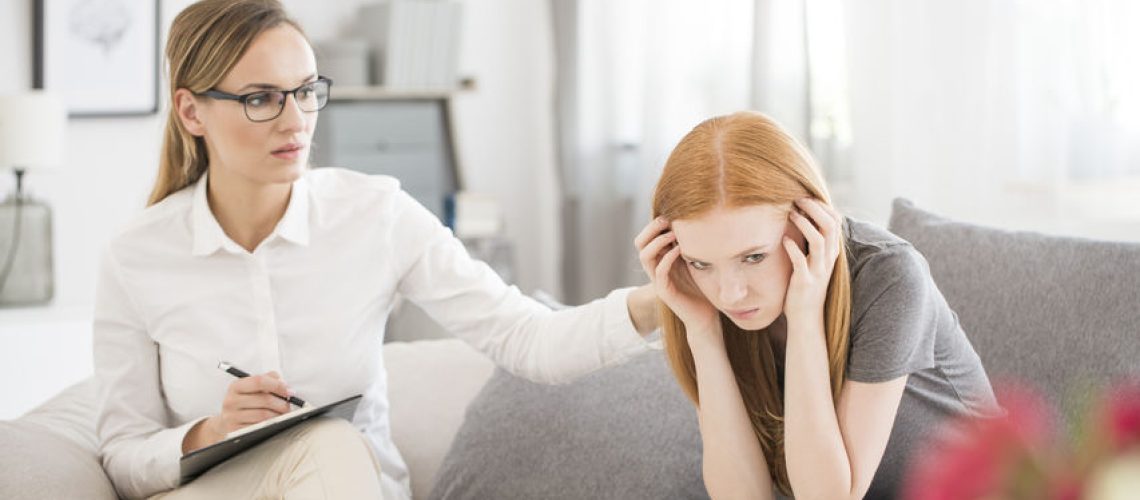 83654119 - young unhappy girl suffering form mental breakdown during session with psychiatrist